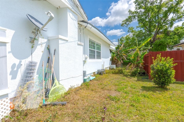 5261 3rd St, Orlando, FL 32810 - view of home's exterior with a yard, stucco siding, and fence