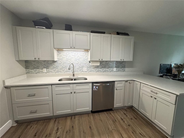 508 Tracey Dr, Panama City, FL 32404 - kitchen featuring dishwasher, a sink, light countertops, a peninsula, and dark wood-style floors