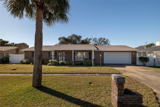 18 Buckingham Dr, Ormond Beach, FL 32176 - ranch-style home with a front yard, a garage, fence, concrete driveway, and brick siding
