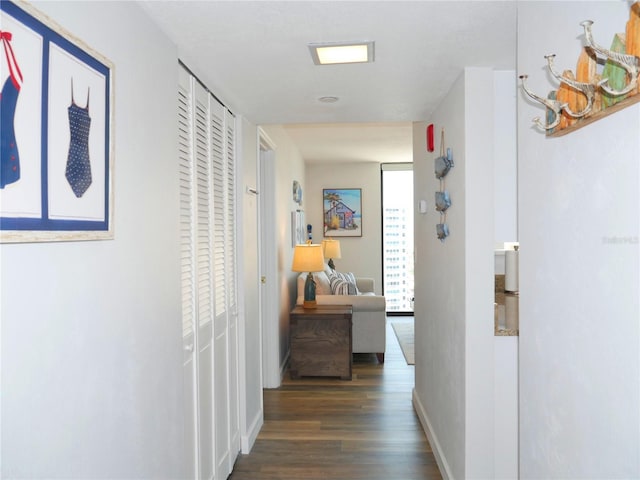 hall featuring baseboards and wood finished floors