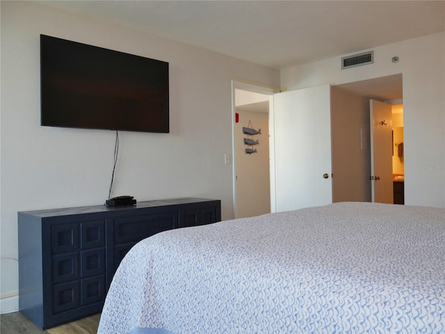 bedroom featuring visible vents and light wood-style flooring