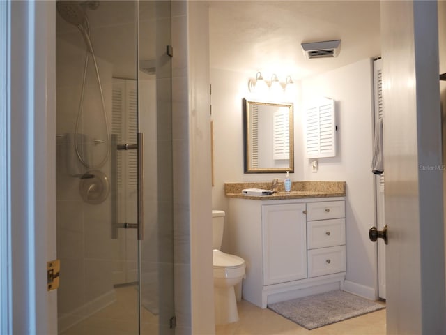 full bath with vanity, tile patterned floors, a shower stall, and toilet