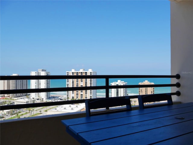 balcony featuring a view of city and a water view