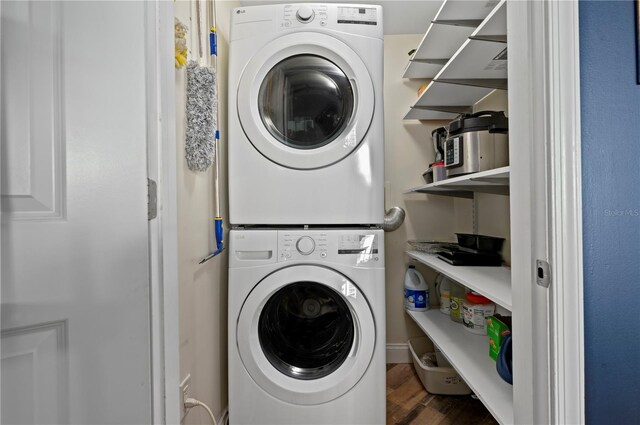 241 Riverside Dr Unit 1909, Daytona Beach, FL 32117 - clothes washing area with stacked washer and clothes dryer and wood finished floors