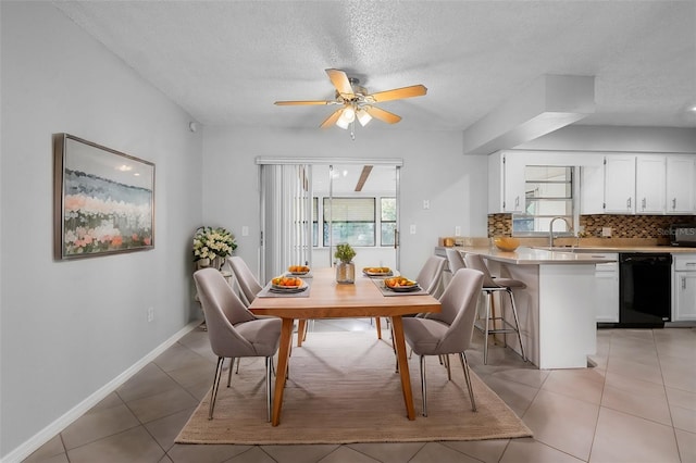 dining room featuring ceiling fan, baseboards, a textured ceiling, and light tile patterned floors