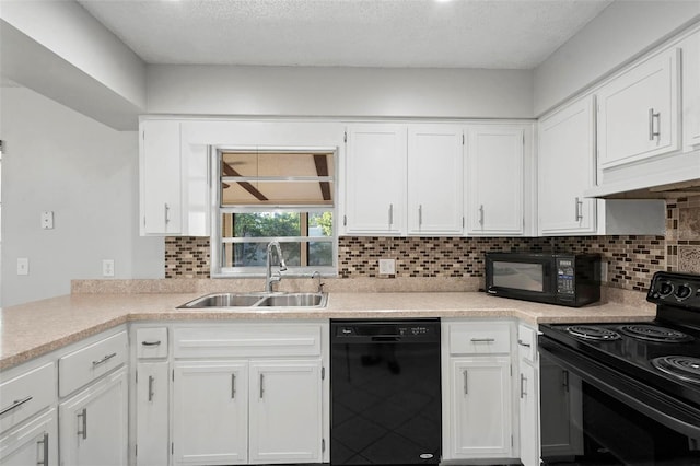 kitchen featuring white cabinetry, a sink, and black appliances