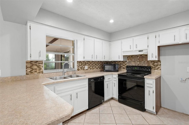 kitchen with black appliances, under cabinet range hood, a sink, and light countertops