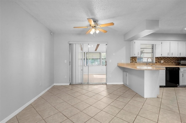 kitchen featuring light countertops, a ceiling fan, black dishwasher, tasteful backsplash, and white cabinetry
