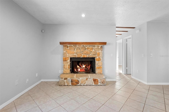 unfurnished living room featuring a stone fireplace, a textured ceiling, baseboards, tile patterned flooring, and recessed lighting