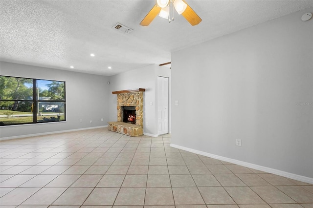 unfurnished living room with visible vents, light tile patterned flooring, a fireplace, a textured ceiling, and ceiling fan