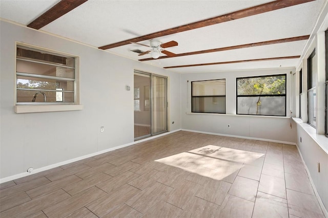spare room featuring ceiling fan, baseboards, and beam ceiling