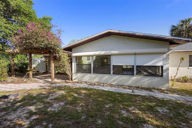 back of house featuring stucco siding