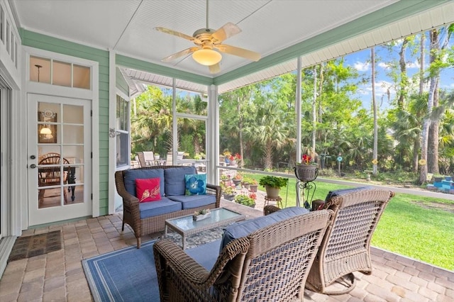 sunroom featuring an outdoor living space and ceiling fan