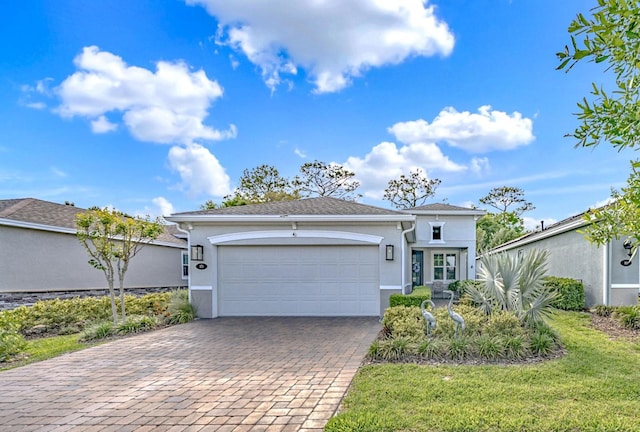 view of front of home with a garage, decorative driveway, and stucco siding
