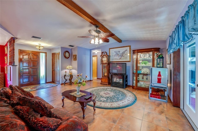 living area featuring a healthy amount of sunlight, tile patterned floors, vaulted ceiling with beams, and visible vents