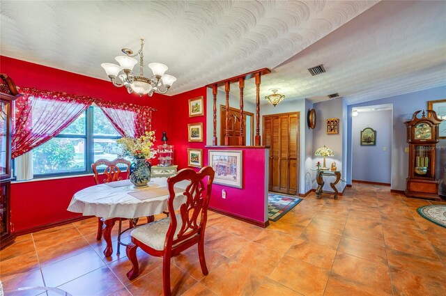 tiled dining space with baseboards, visible vents, and a chandelier