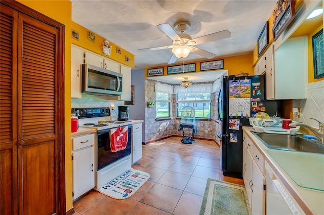 kitchen featuring a sink, white cabinetry, a ceiling fan, white appliances, and light countertops