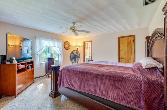 bedroom with baseboards, a ceiling fan, visible vents, and light colored carpet