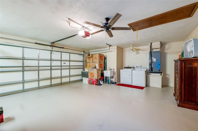 garage featuring ceiling fan, a garage door opener, and independent washer and dryer