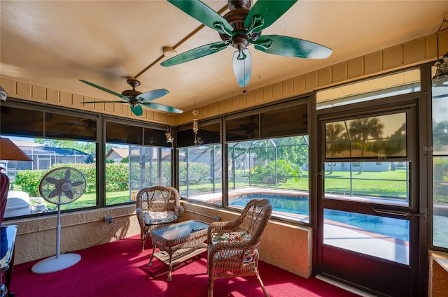 sunroom / solarium featuring a ceiling fan