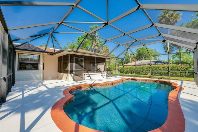 outdoor pool featuring a patio area, a lanai, and a sunroom