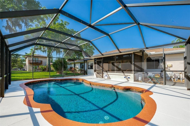 pool featuring glass enclosure and a patio