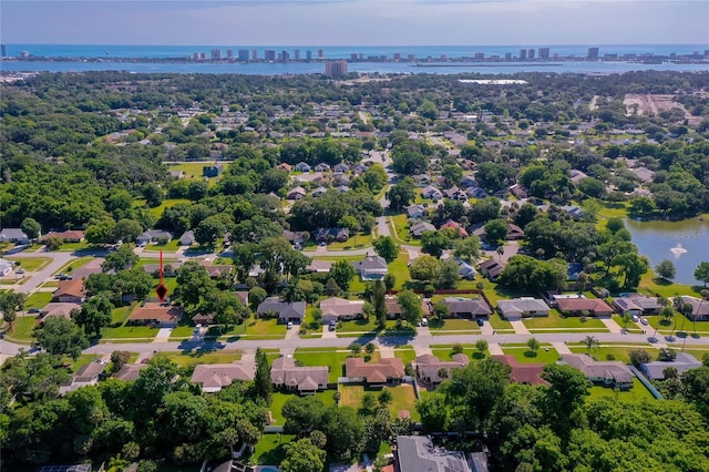 drone / aerial view featuring a city view and a water view