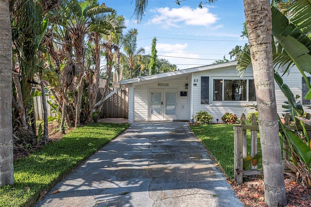 82 Margaret Rd, Ormond Beach, FL 32176 - view of front of property featuring driveway, french doors, and fence