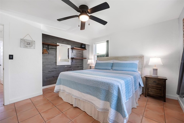 82 Margaret Rd, Ormond Beach, FL 32176 - bedroom featuring wooden walls, light tile patterned floors, ceiling fan, and baseboards