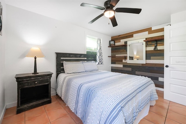 82 Margaret Rd, Ormond Beach, FL 32176 - tiled bedroom featuring wood walls and a ceiling fan