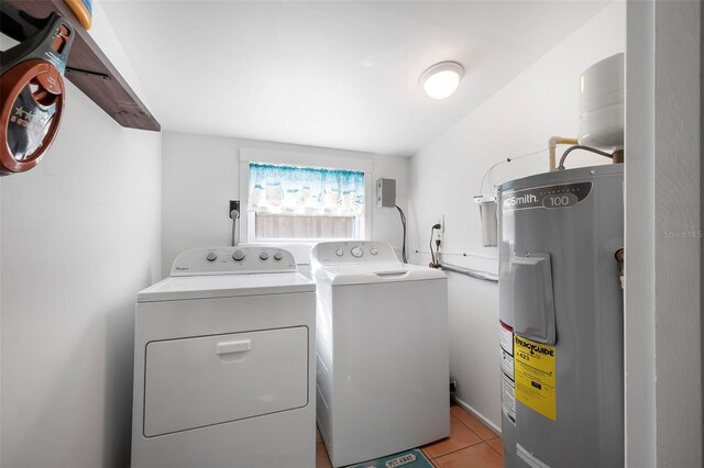 82 Margaret Rd, Ormond Beach, FL 32176 - laundry area featuring washer and dryer, water heater, laundry area, and light tile patterned floors