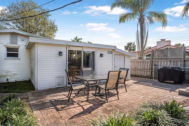 82 Margaret Rd, Ormond Beach, FL 32176 - view of patio with outdoor dining space, fence, and area for grilling
