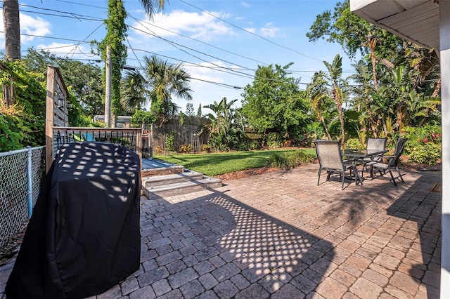 82 Margaret Rd, Ormond Beach, FL 32176 - view of patio / terrace with outdoor dining space, a grill, and fence private yard