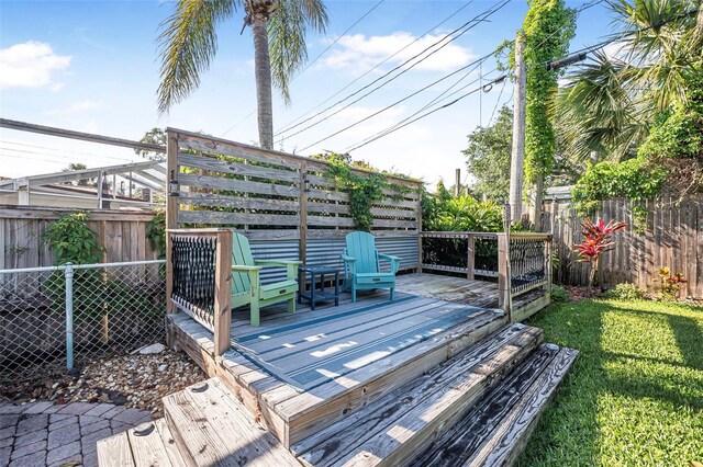 82 Margaret Rd, Ormond Beach, FL 32176 - deck featuring a fenced backyard and a lawn