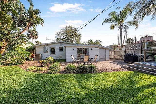 82 Margaret Rd, Ormond Beach, FL 32176 - back of house with a patio, central air condition unit, a yard, and fence