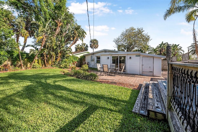 82 Margaret Rd, Ormond Beach, FL 32176 - rear view of property featuring a yard, a patio, and fence