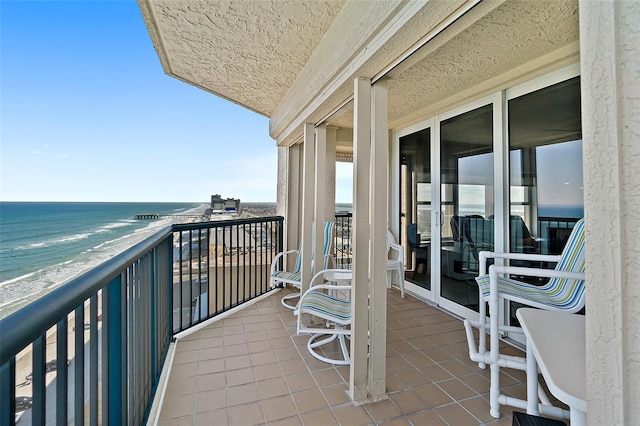 balcony with a beach view and a water view