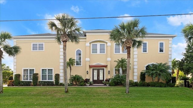 3310 John Anderson Dr, Ormond Beach, FL 32176 - view of front of house with french doors, a front lawn, and stucco siding