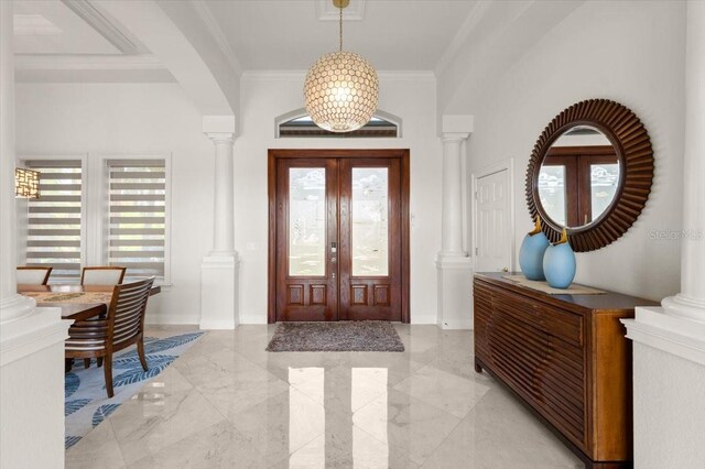 3310 John Anderson Dr, Ormond Beach, FL 32176 - entrance foyer with crown molding, baseboards, ornate columns, and marble finish floor