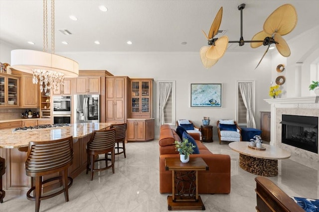 3310 John Anderson Dr, Ormond Beach, FL 32176 - living room featuring crown molding, a fireplace, visible vents, recessed lighting, and marble finish floor