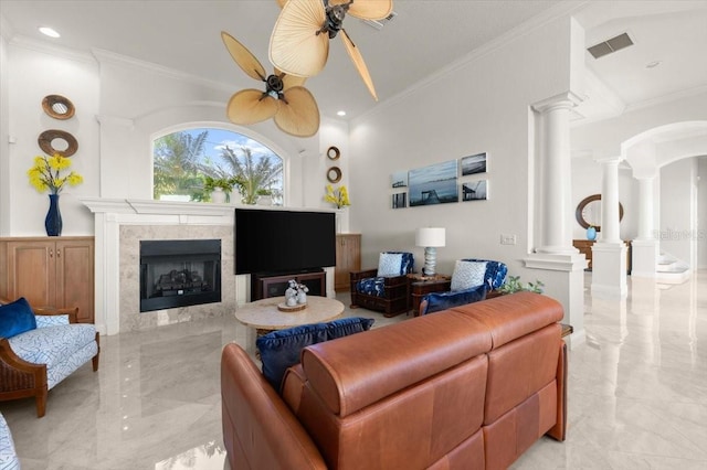 3310 John Anderson Dr, Ormond Beach, FL 32176 - living area with visible vents, ceiling fan, a fireplace, ornate columns, and marble finish floor