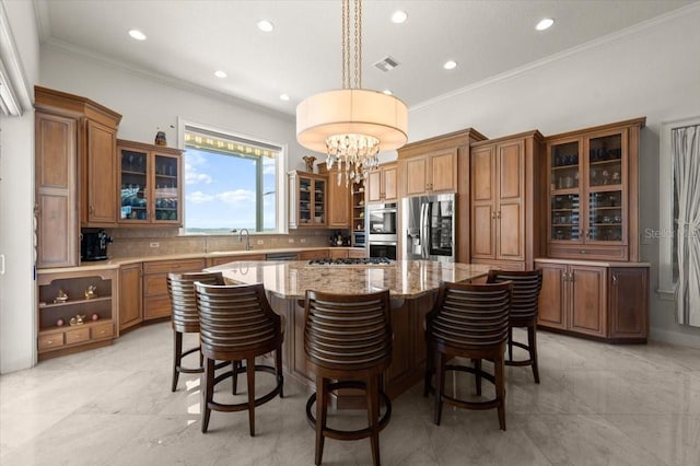 3310 John Anderson Dr, Ormond Beach, FL 32176 - kitchen featuring an inviting chandelier, brown cabinetry, a center island, a sink, and stainless steel appliances