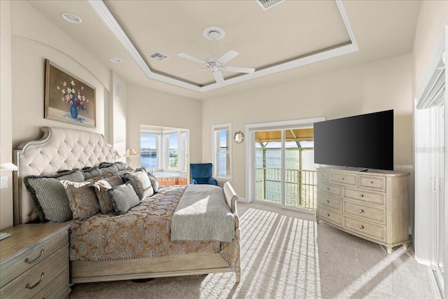 3310 John Anderson Dr, Ormond Beach, FL 32176 - bedroom featuring access to outside, light carpet, visible vents, multiple windows, and a raised ceiling