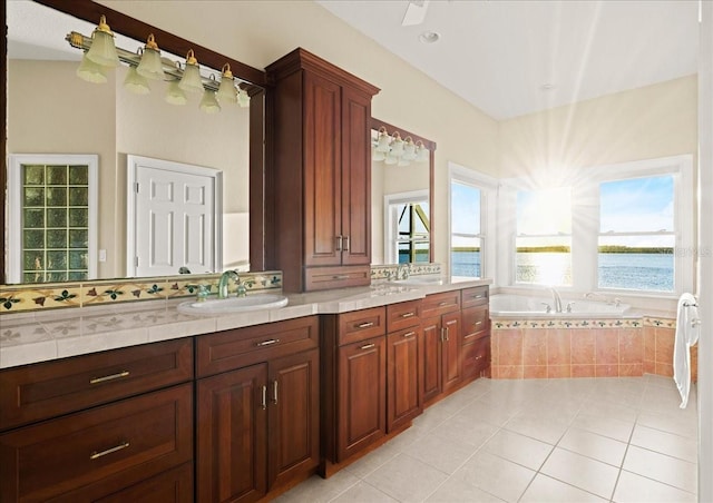 3310 John Anderson Dr, Ormond Beach, FL 32176 - full bathroom featuring a sink, a water view, double vanity, tile patterned floors, and a garden tub