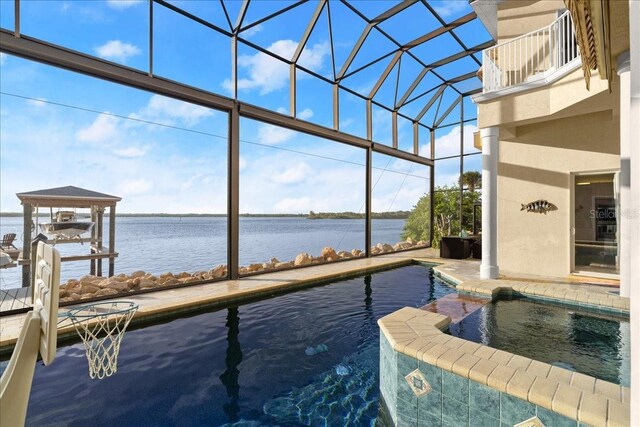3310 John Anderson Dr, Ormond Beach, FL 32176 - view of swimming pool featuring a water view, a pool with connected hot tub, a patio, and glass enclosure