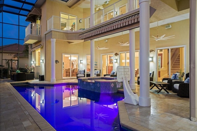 3310 John Anderson Dr, Ormond Beach, FL 32176 - view of pool featuring a pool with connected hot tub, outdoor lounge area, a ceiling fan, glass enclosure, and a patio