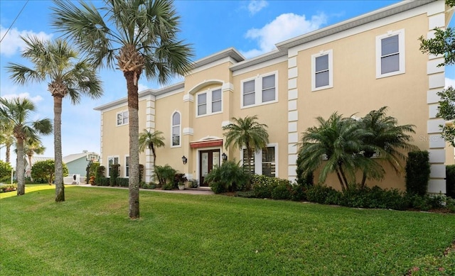3310 John Anderson Dr, Ormond Beach, FL 32176 - view of front of home with a front yard, french doors, and stucco siding