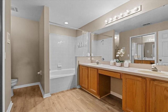bathroom featuring a sink, wood finished floors, and visible vents