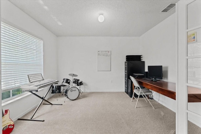 office area with carpet floors, baseboards, a textured ceiling, and visible vents