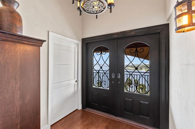 761 Marina Point Dr Unit 7610, Daytona Beach, FL 32114 - entrance foyer with dark wood-type flooring, french doors, and a chandelier